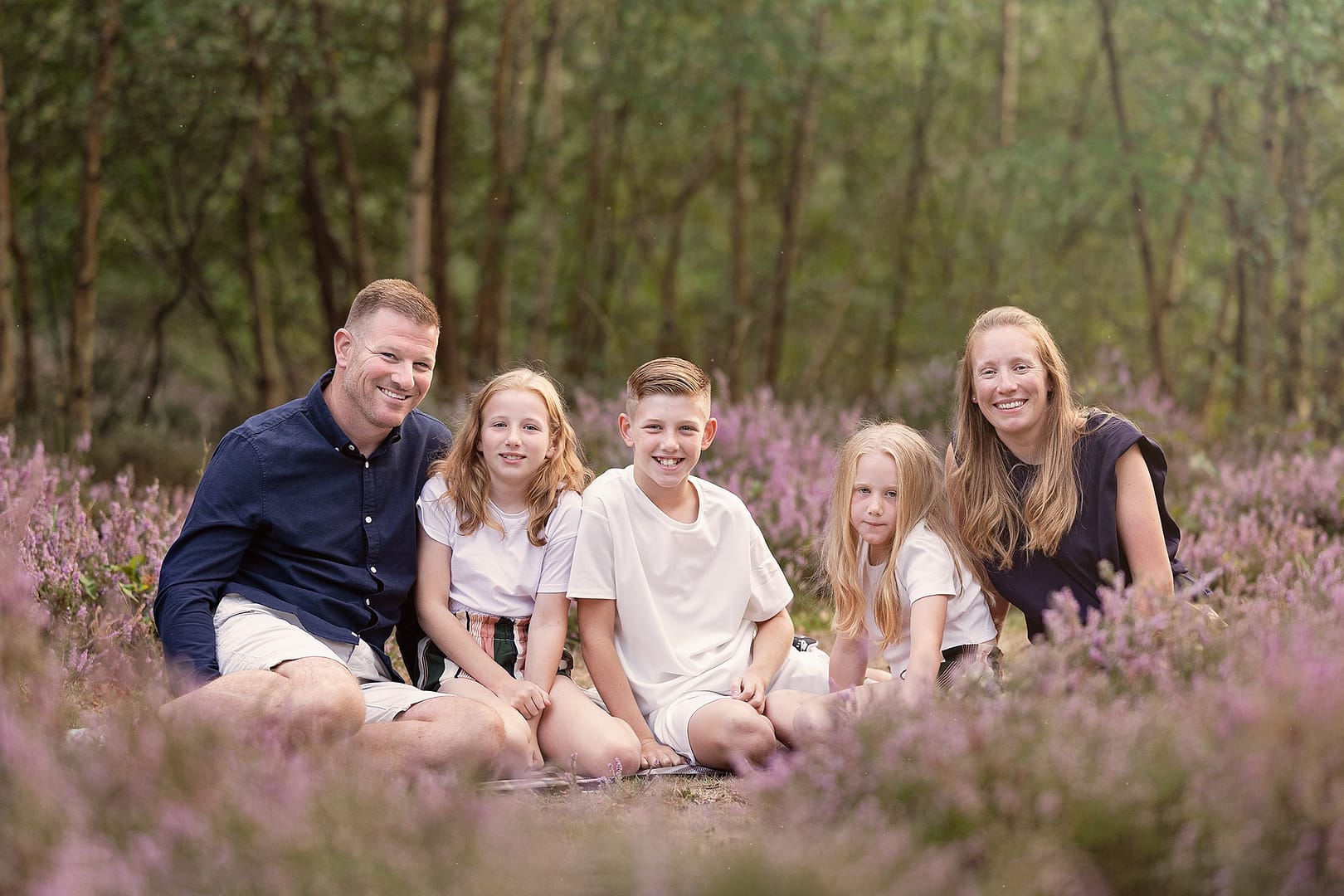 Family sitting outdoors amongst the purple heather in Sutton Park.  Taken by family photographer Nicki Byrne Photography, Sutton Coldfield birmingham
