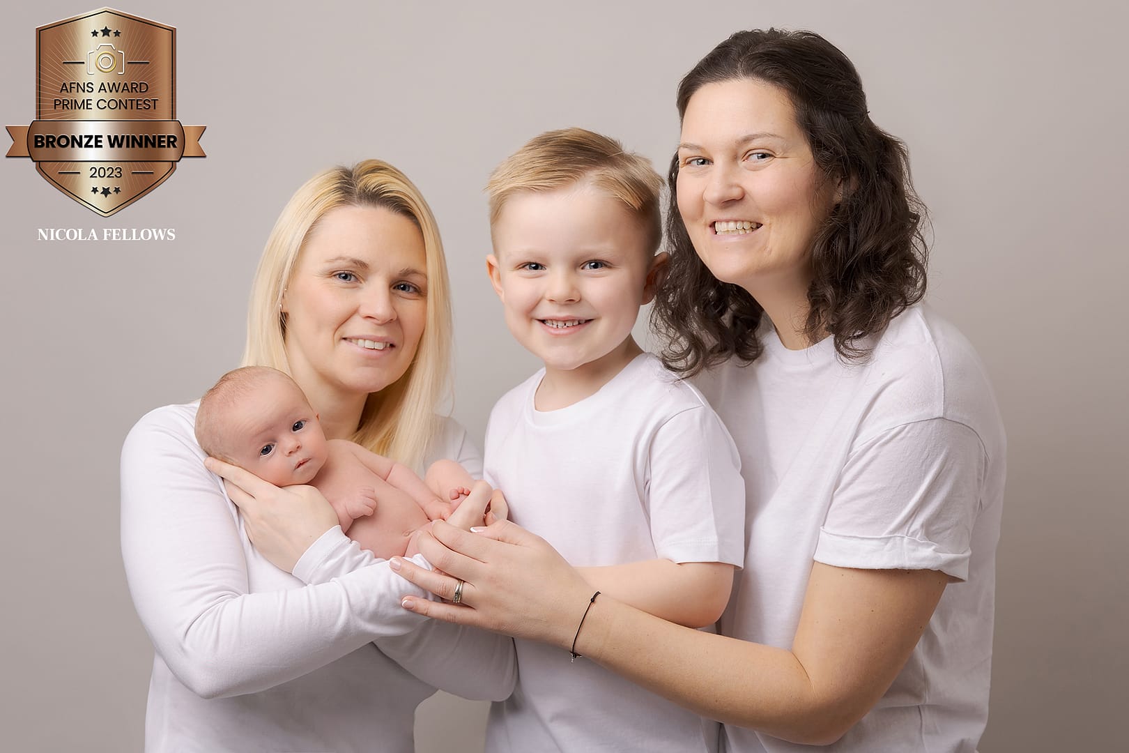 award winning newborn family photo. Newborn with his Moms and bigger brother all wearing white. Taken by newborn and family photographer Sutton Coldfield newborn and family photographer birmingham