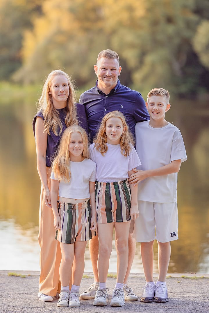 Family of 5 posing infront of Bracebridge Lake in Sutton park.  Taken by Birmingham Family Photographer, Nicki Byrne Photography, Sutton Coldfield