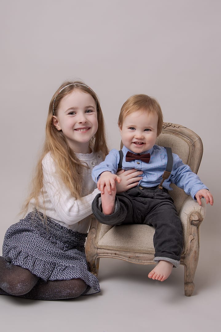 Siblings celebrating first birthday today during the cake smash, Sutton Coldfield, Birmingham