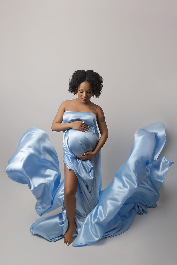 Gorgeous Mother-to-be wrapped in a blue floaty silk taken by award winning maternity photographer Nicki Byrne Photography, maternity photographer Sutton Coldfield birmingham