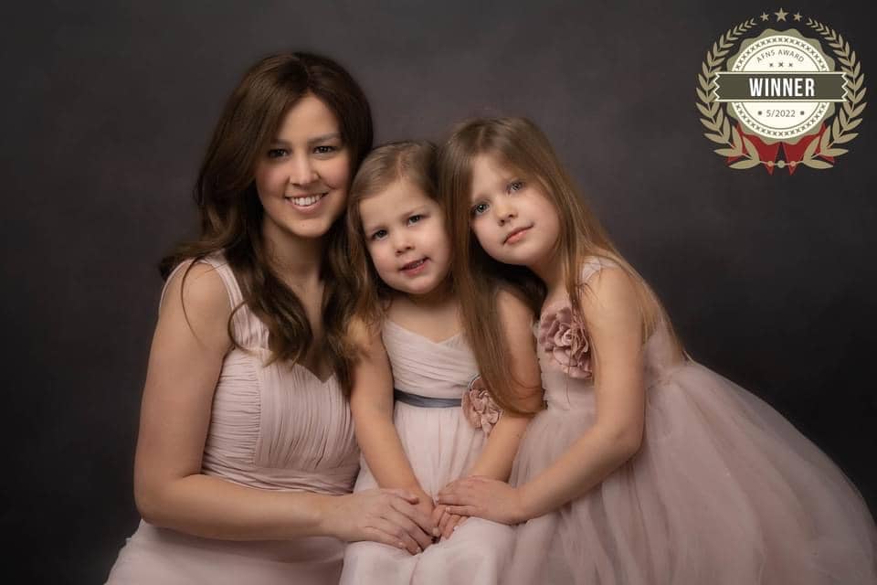Gorgeous, soft image of a mother with her two daughters, all dressed in dusky pink tulle dresses.  Taken by family photographer Nicki Byrne Photography, Sutton Coldfield Birmingham